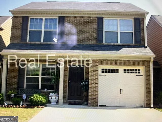 view of front facade with an attached garage, concrete driveway, and brick siding