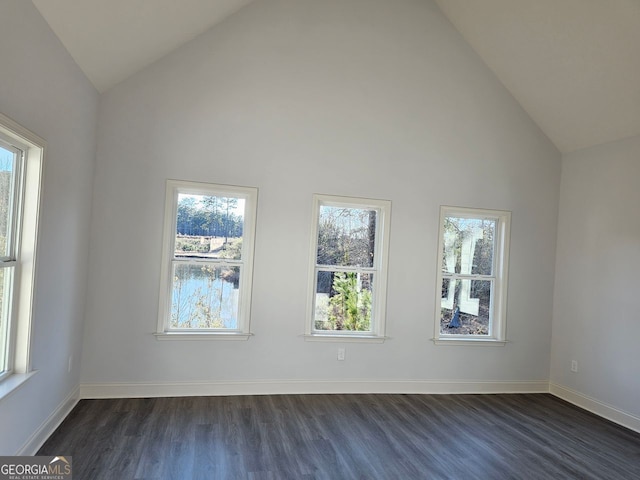 interior space with high vaulted ceiling, dark wood finished floors, and baseboards