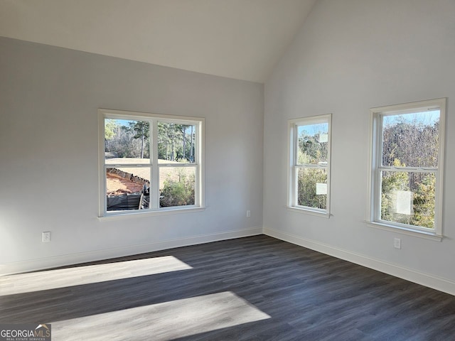 unfurnished room with lofted ceiling, dark wood finished floors, and baseboards