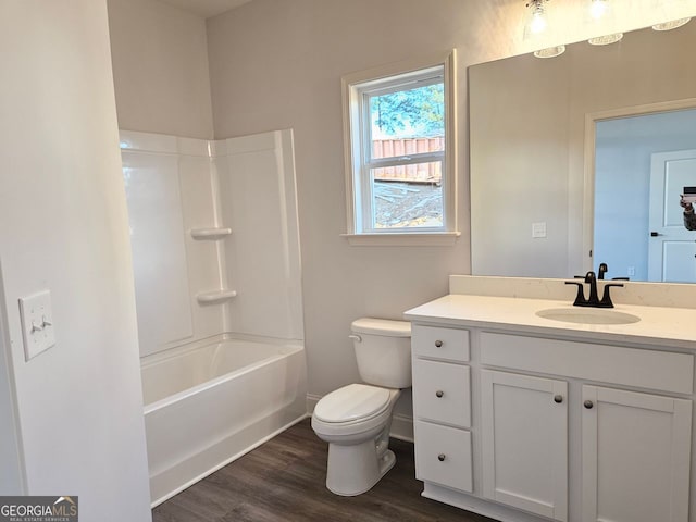 bathroom featuring shower / tub combination, toilet, wood finished floors, vanity, and baseboards