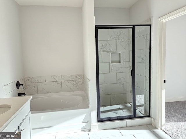 bathroom with a stall shower, a bath, and vanity