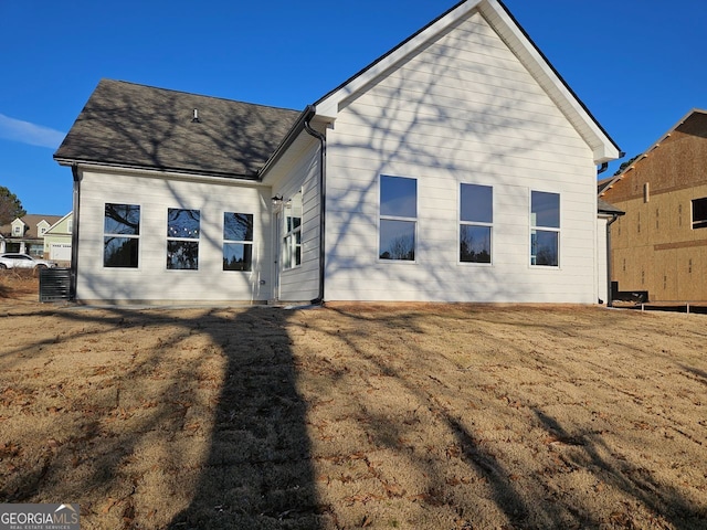 back of property featuring a lawn