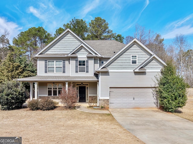 craftsman inspired home featuring stone siding, a shingled roof, covered porch, and concrete driveway