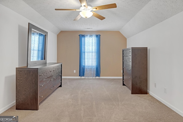 interior space with a wealth of natural light, lofted ceiling, and a textured ceiling