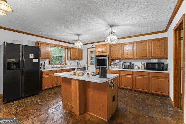 kitchen with light countertops, ornamental molding, stone finish flooring, a kitchen island, and black appliances