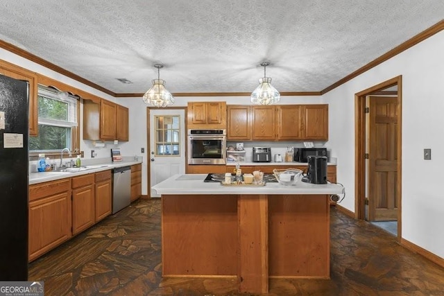 kitchen with black appliances, light countertops, a sink, and decorative light fixtures