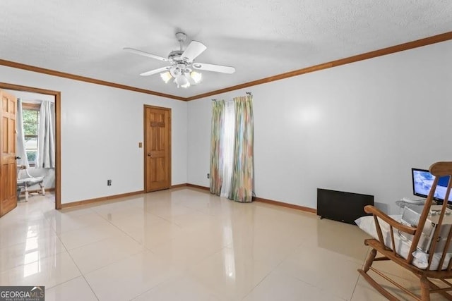 sitting room featuring crown molding, light tile patterned floors, a textured ceiling, and baseboards