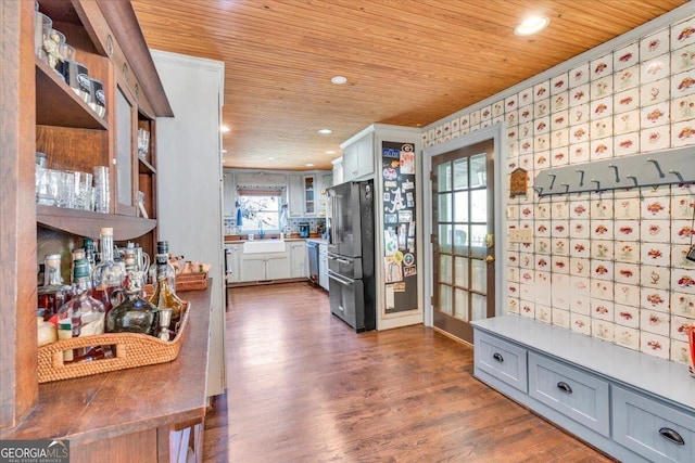 kitchen featuring dark wood finished floors, high end fridge, wooden ceiling, and a sink