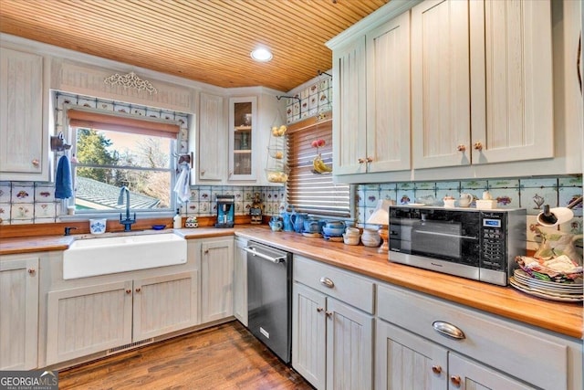 kitchen with dishwasher, a sink, a wealth of natural light, and decorative backsplash