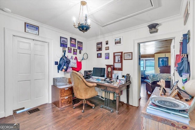 office space with ornamental molding, visible vents, an inviting chandelier, and wood finished floors