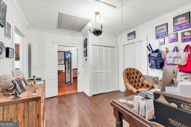 office area with wood finished floors, attic access, and crown molding