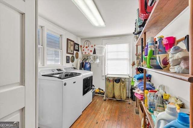 kitchen with light wood-type flooring, washer and dryer, and light countertops