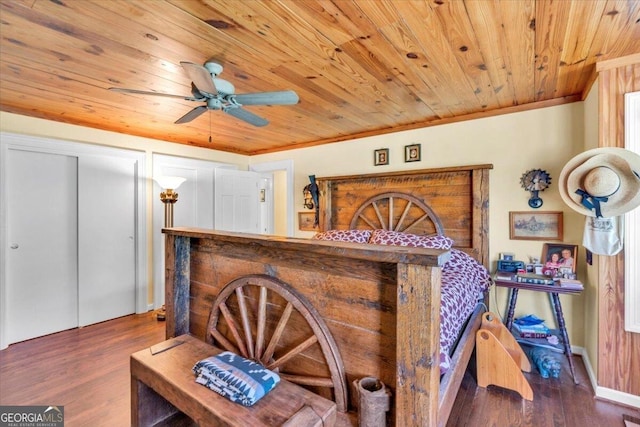 bedroom featuring a dry bar, wooden ceiling, ornamental molding, and wood finished floors