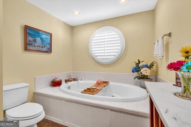 full bath featuring recessed lighting, vanity, toilet, and a bath