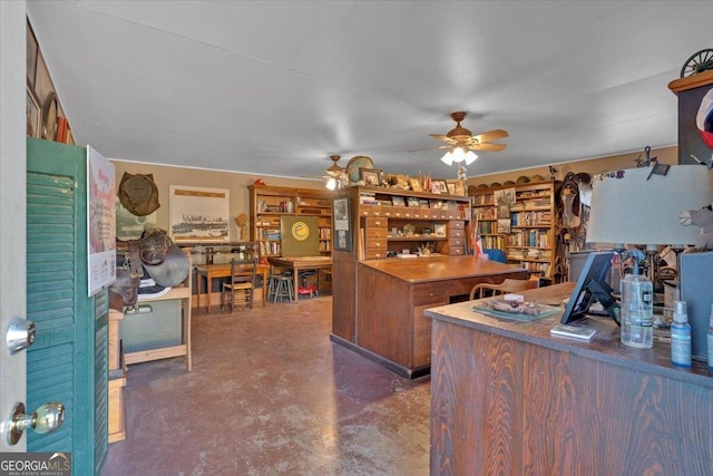 office space featuring a ceiling fan and concrete flooring