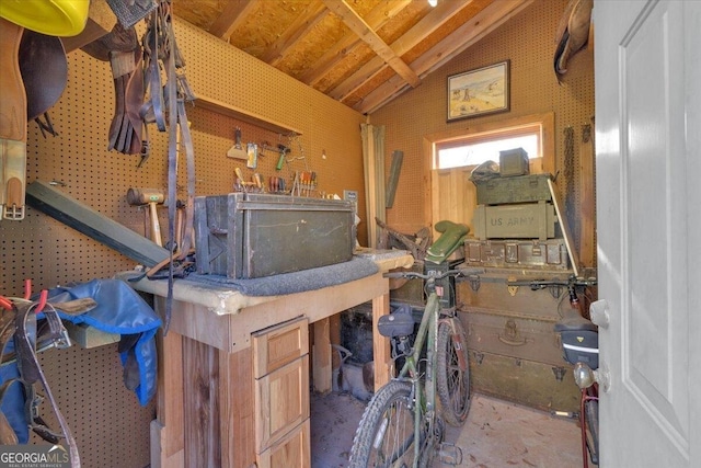 interior space with lofted ceiling and a workshop area