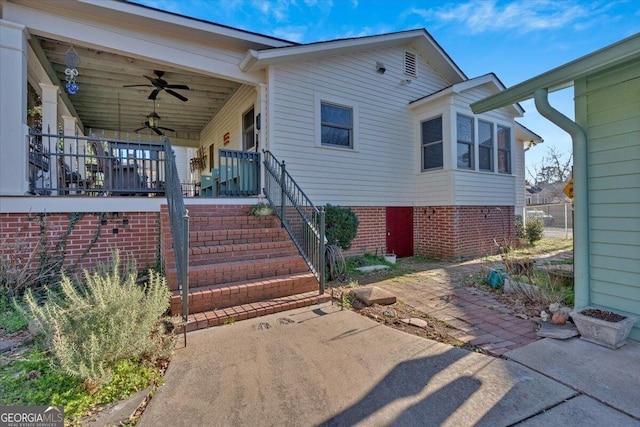 view of front facade featuring covered porch, stairs, and a ceiling fan