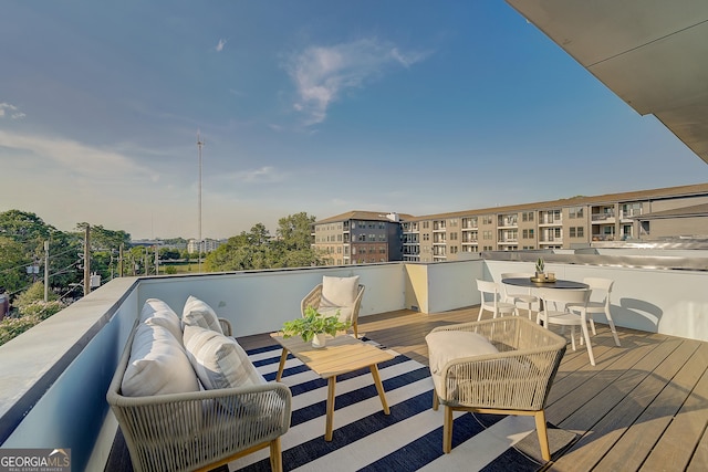 wooden deck featuring outdoor dining area and an outdoor hangout area