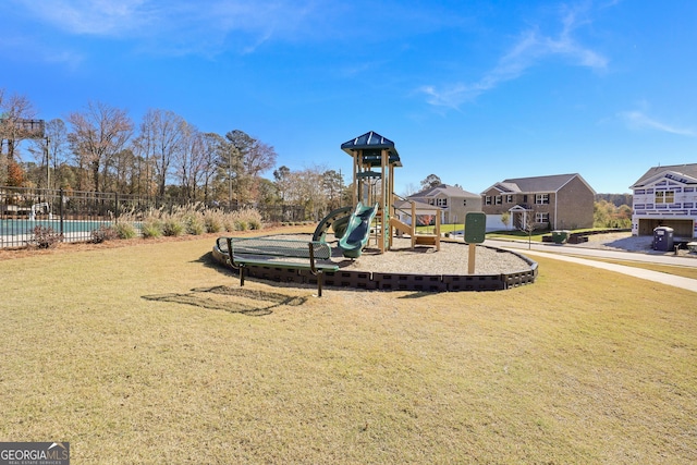 community playground with fence and a lawn