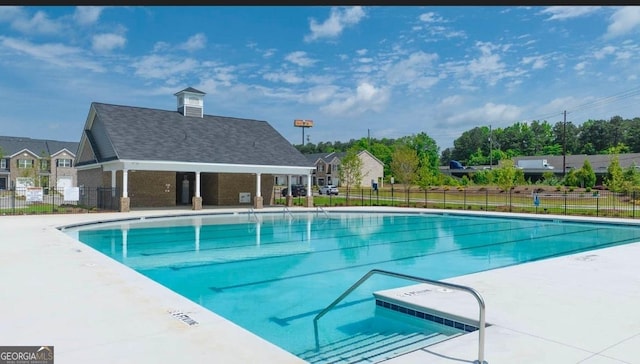 pool featuring a patio area and fence