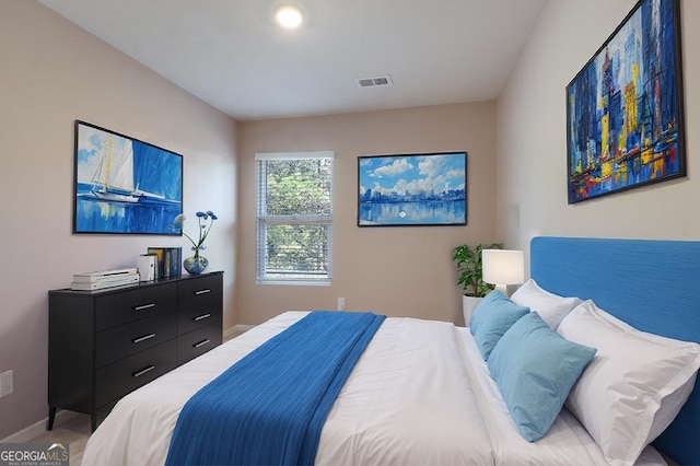 bedroom with light carpet, visible vents, and baseboards