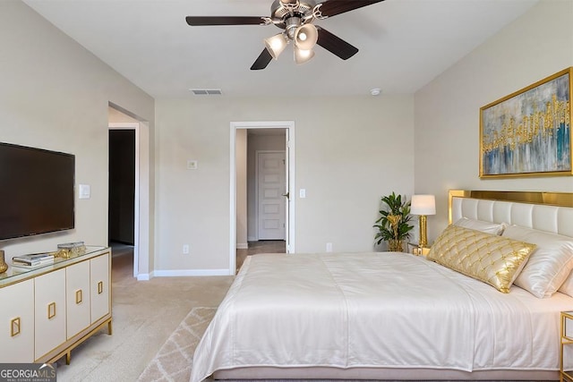 bedroom with a ceiling fan, light colored carpet, visible vents, and baseboards