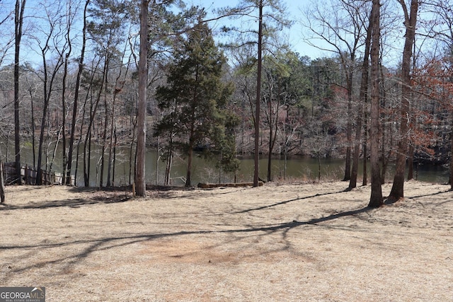 exterior space with a water view and a wooded view