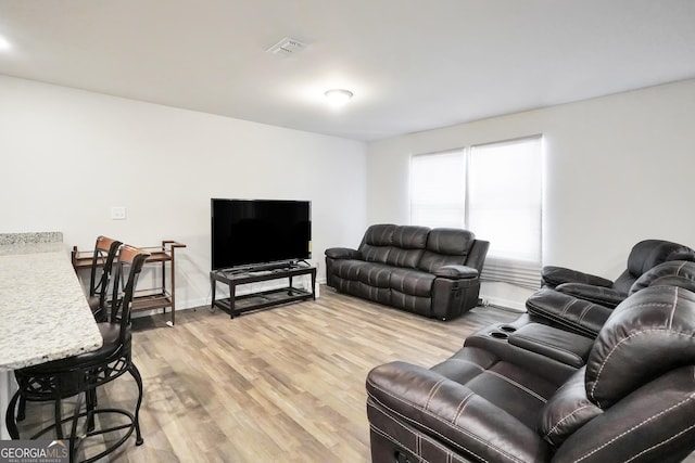 living area with light wood finished floors and visible vents