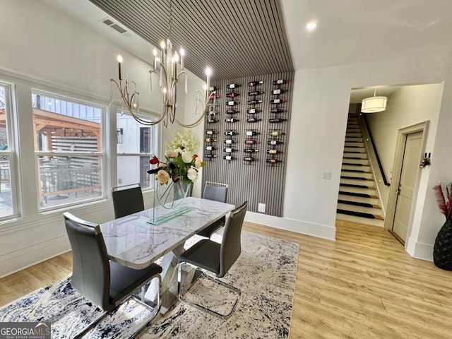 dining room featuring light wood-type flooring, visible vents, and plenty of natural light