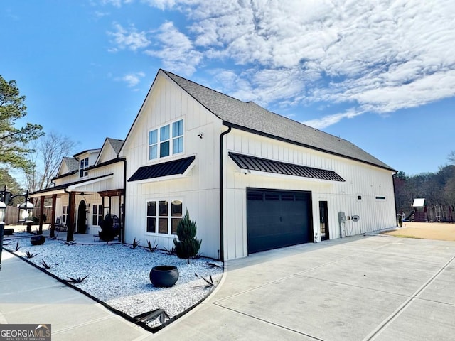 view of home's exterior featuring a shingled roof, concrete driveway, metal roof, a standing seam roof, and board and batten siding