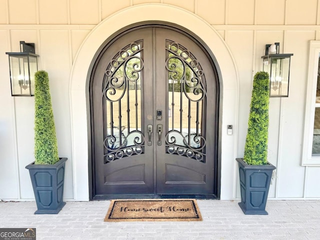 entrance to property with french doors and board and batten siding