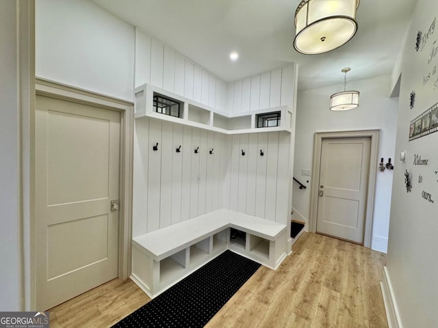 mudroom with light wood-style floors and baseboards