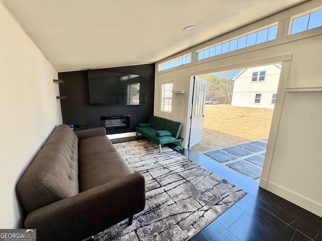 living area with baseboards and wood finished floors