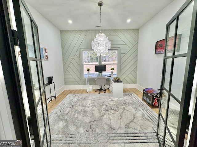 office featuring baseboards, recessed lighting, light wood-type flooring, and an inviting chandelier