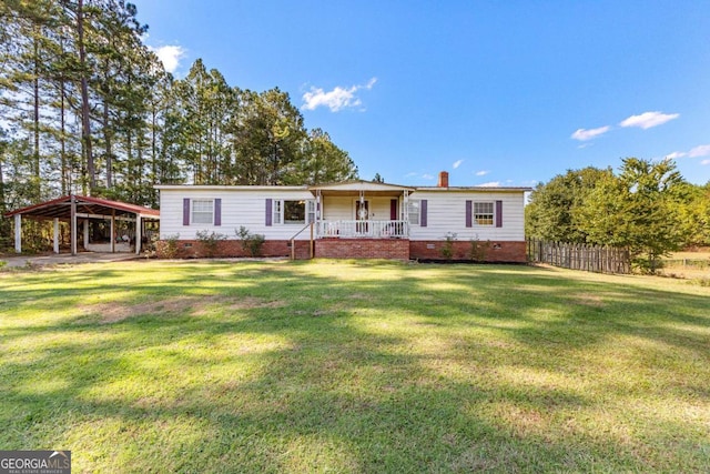 view of front facade with a detached carport, covered porch, crawl space, fence, and a front lawn