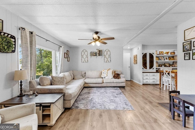 living area with light wood-type flooring and ceiling fan