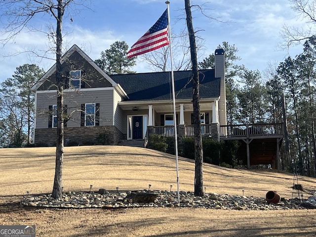 view of front of property featuring a chimney and a porch