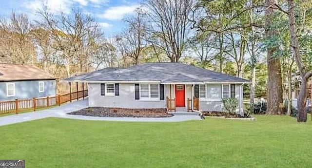 view of front of home with driveway, a front lawn, and fence