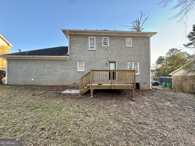 back of house featuring crawl space, brick siding, fence, and a deck