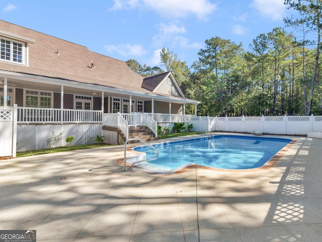 view of swimming pool with a fenced in pool, fence, and a patio