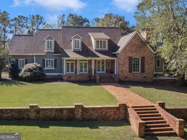 cape cod home featuring a shingled roof, a front yard, french doors, and crawl space