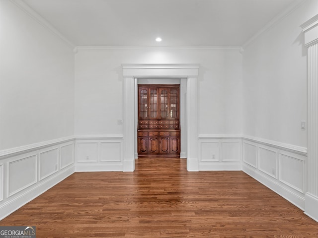 spare room featuring crown molding and wood finished floors