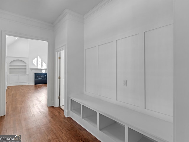 mudroom featuring built in features, a fireplace, ornamental molding, and wood finished floors