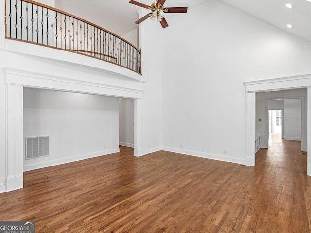 unfurnished living room featuring high vaulted ceiling, visible vents, ceiling fan, and wood finished floors