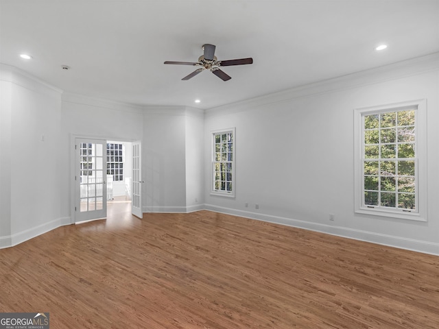 unfurnished room with ornamental molding, french doors, and wood finished floors