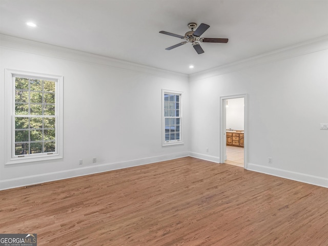 unfurnished bedroom with ornamental molding, baseboards, and light wood finished floors