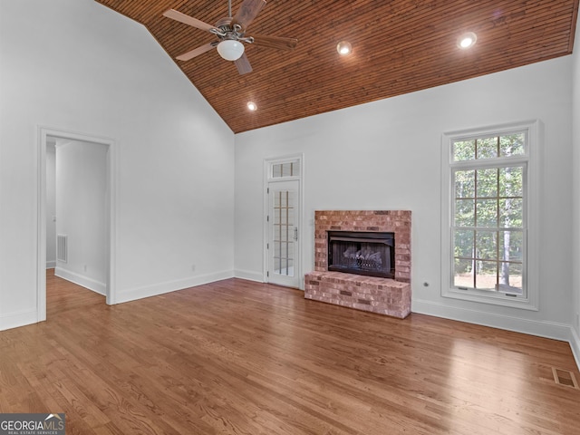 unfurnished living room with visible vents, wood ceiling, wood finished floors, high vaulted ceiling, and baseboards