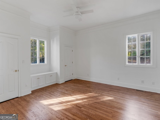 unfurnished bedroom with ornamental molding, baseboards, and wood finished floors