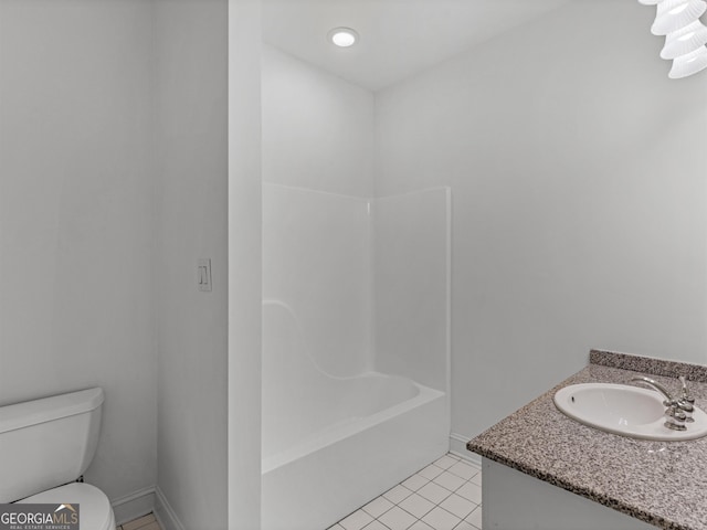 bathroom with baseboards, vanity, toilet, and tile patterned floors