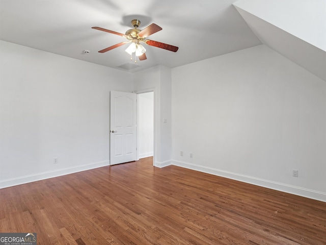 interior space featuring vaulted ceiling, wood finished floors, a ceiling fan, and baseboards